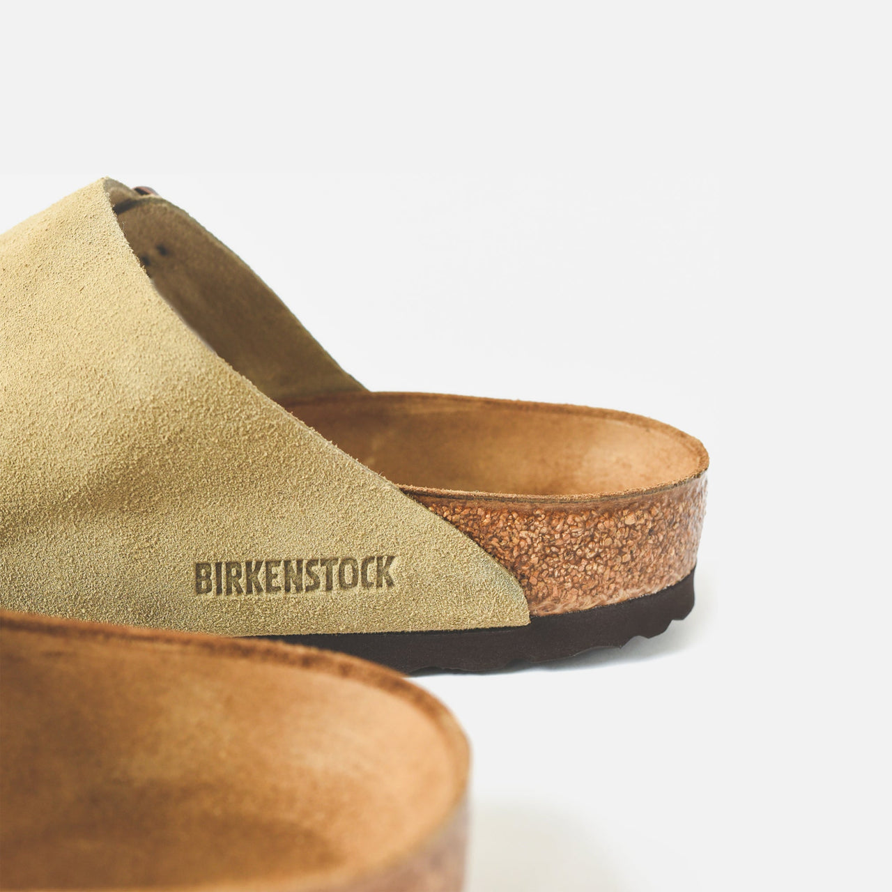 A close-up image of Birkenstock Women's Arizona Suede Taupe sandals with adjustable straps and a comfortable footbed