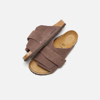 Thumbnail for Woman wearing Birkenstock Kyoto Nubuck Roast sandals walking on a sandy beach
