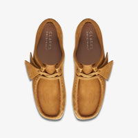 Thumbnail for Pair of [26169923] Womens CLARKS WALLABEE - BROWN shoes in a natural setting, ideal for outdoor activities and everyday wear