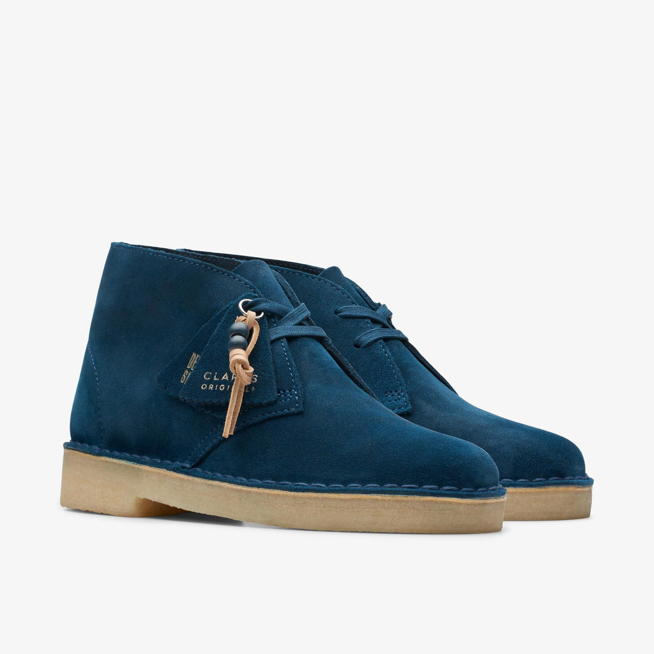 A stylish and comfortable pair of women's Clarks Desert Boots in deep blue suede