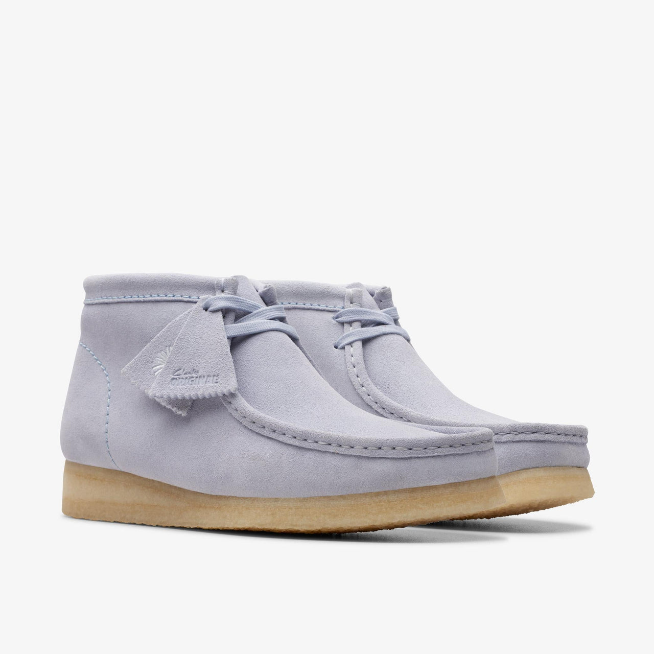 A close-up image of the Mens Clarks Wallabee Boot in Cloud Grey Suede, showcasing the classic moccasin toe and comfortable crepe sole