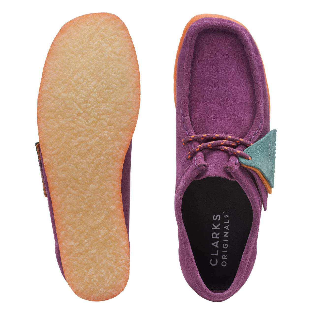 Pair of womens Clarks Wallabee shoes in purple suede on a white background