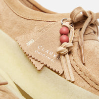 Thumbnail for Pair of Clarks Originals Wallabee Cup Women's Warm Beige Suede 261732524 shoes in a natural setting